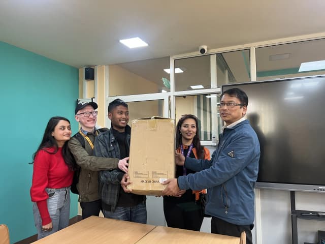 Founder & Director Mr. Abhishek Shahi, Cofounder & Treasurer Ms. Sanjiya Shrestha, It & Creative Specialist Mr. Joon Shakya & Discipline Monitor & Executive Member Ms. Deepika Shahi handing the 3D printer to Mr. Jeetendra Manandhar Administrator of St. Xavier's College, Maitighar, Kathmandu.