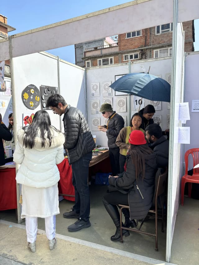 Project secretary Karmendra Shrestha is explaining a visitor in the stall of SET exhibition. In the background, project members Joon Shakya, Sanskriti Pokharel, Romee Jijicha and founders of CFC Abhishek Shahi and Sanjiya Shrestha are observed.