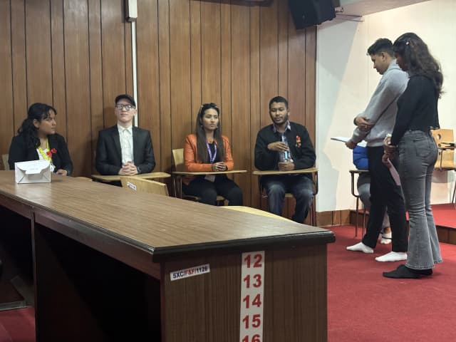 Founder and Director of CFC Abhishek Shahi is speaking. On his right, Cofounder and Treasurer Sanjiya Shrestha and project members Joon Shakya and Shrijana Katwal is observed. Sangam Khadka and Saskriti Pokharel who acted as the MCs of the event are standing in front.