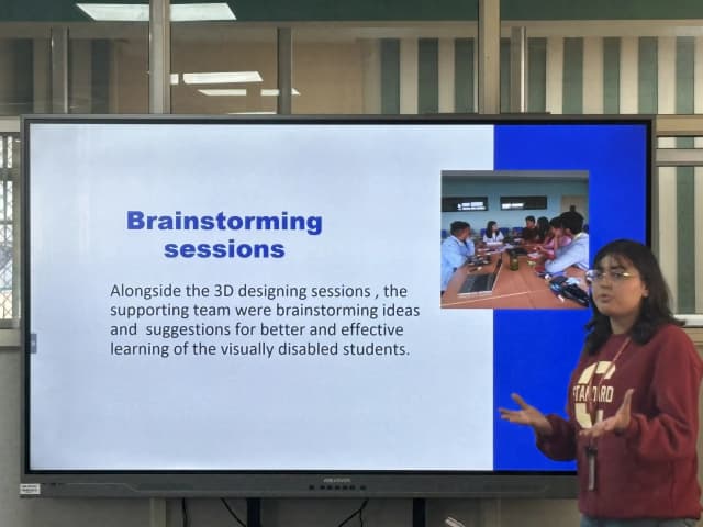 Project member Khushi Subedi is explaining about Brain Storming session of 3D design team with locally available resources. On the right, a picture of Intern Design Instructor Victoria taking class is also displayed.