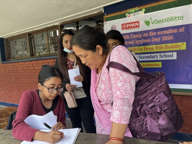 One of our project member Garima Shakya is registering a female who came to check-up during the health camp.