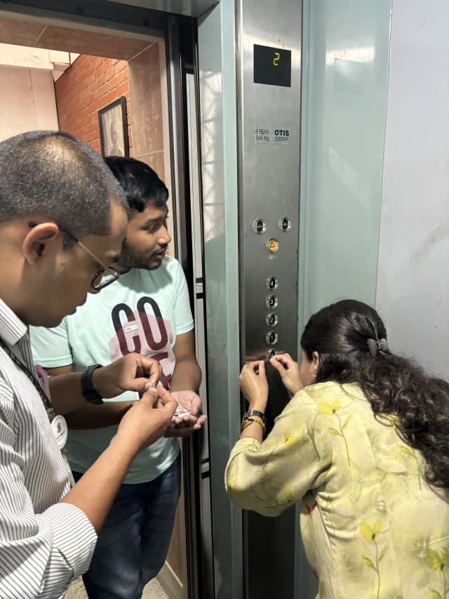 CFC Secretary Ms. Deepika Shahi is pasting the braille labels in the buttons where Mr. Anup Basnet – International Collaboration & Liaison Officer of SXC and Founder & President of CFC Mr. Abhishek Shahi is supporting her.