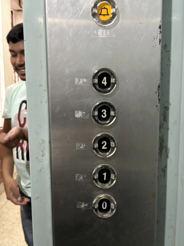 A picture of braille label placed in the buttons of the lift.