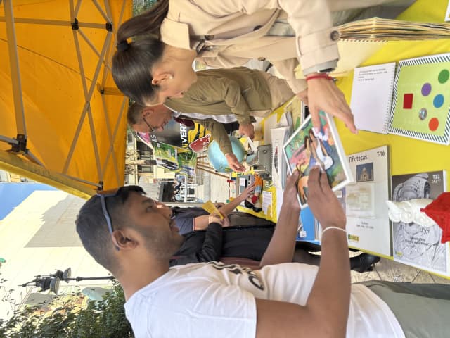 Our Founder Abhishek Shahi is touching the tactile painting of 2 girls displayed in the exhibition.