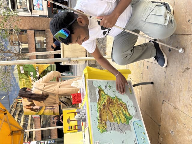 Our Founder Abhishek Shahi touching the 2D tactile map of Spain, kept in the display at exhibition.