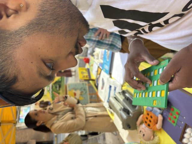 Our Founder Abhishek Shahi touching the accessible board game ‘BINGO’ specially made for individual with visual disabilities.