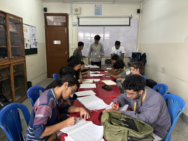 Our founder and 2 of the officers are explaining and demonstrating the braille and other project members are taking note of the important points.