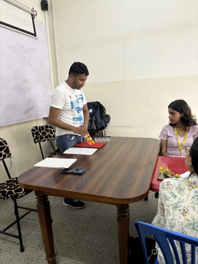 Our Founder who is also the facilitator of this workshop, is explaining about braille dots using Ping-Pong balls and crate.