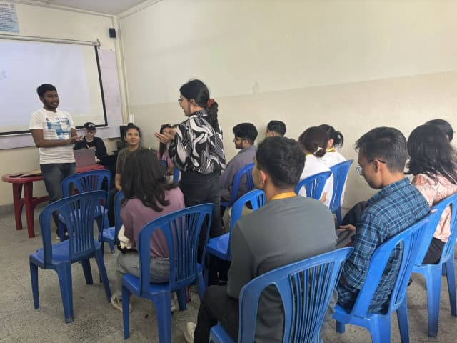 One of the participants Ms. Sanskriti Ghimire Khatri is speaking. In the background, our founder is standing in the front and other participants of the events are observed being seated.