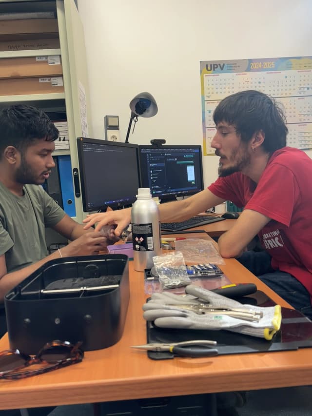 A picture where our Founder Abhishek Shahi is touching the wheel prototype resin model and Miguel is explaining about the resin and its characteristics.