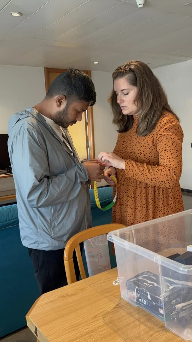 Our Founder Abhishek Shahi is touching the measuring tape kept at the ONCE and Belén – the Técnico Rehabilitación is supporting him.