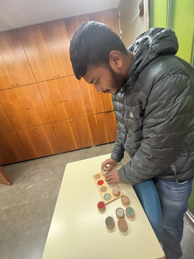 Our Founder Abhishek Shahi is touching the board game to teach children with visual disabilities to understand different texture.