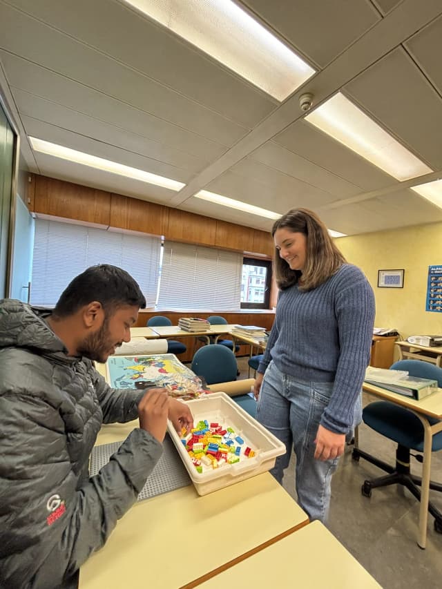 Our Founder Abhishek Shahi is touching the Lego game designed for visual disabilities. In the background, Belén is also observed.