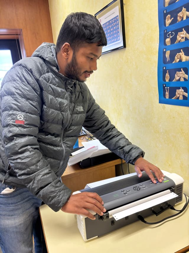 Our Founder Abhishek Shahi is touching the personal use braille printer.