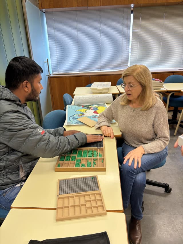 Our Founder Abhishek Shahi is touching the tactile braille mathematical calculation learning kit. One of the staff is teaching him to calculate simple expressions.