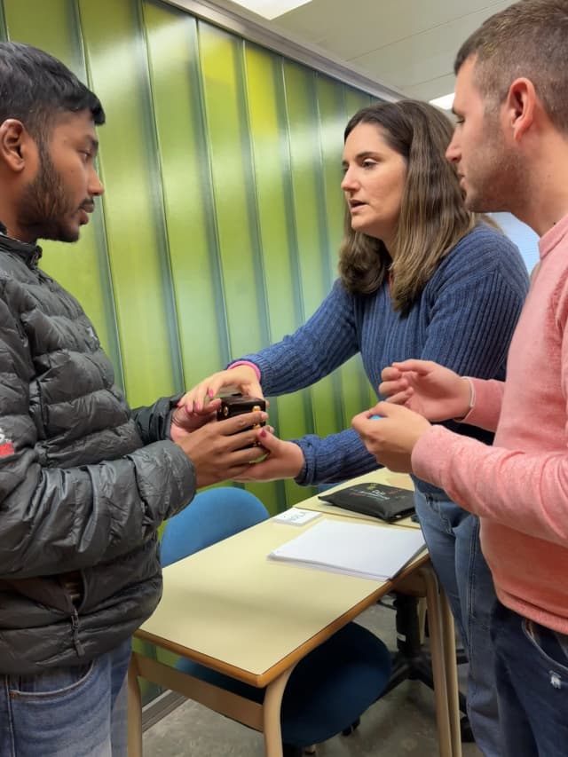 Belén is teaching our Founder Abhishek Shahi to use the big braille cube. In the background, one of the braille teachers is also observed.