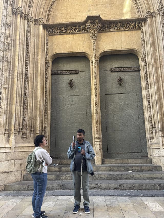 A picture taken in one of the gate of La Lonja where our Founder Abhishek Shahi is listening to the audio device and Fanny Collado is observing him.