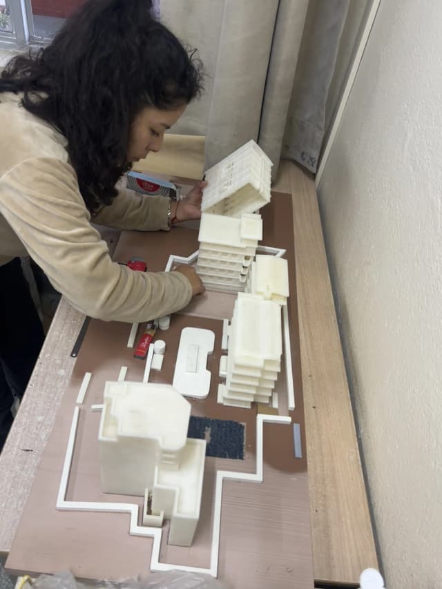 A picture of our Intern Architect for Accessibility (2024 - 2025) Ms. Katherine Gumiel Silva working on to complete the Maqueta of the St. Xavier’s College.