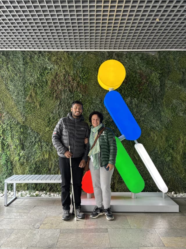 Our Founder Abhishek Shahi and Fanny Collado is posing Infront of ONCE logo. The logo of ONCE appears as a man walking with his white cane.