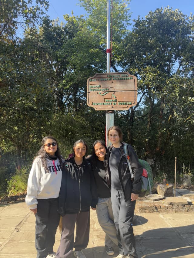 A group picture of 4 female project members taken Infront of the map.